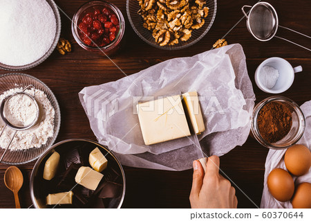 Top view female's hand cut butter among 60370644