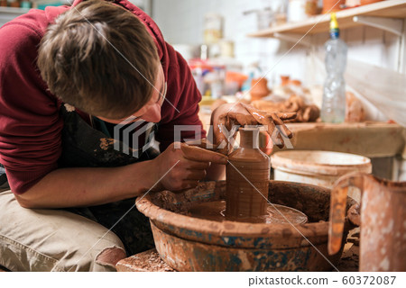 Potter at work. Workshop. 60372087