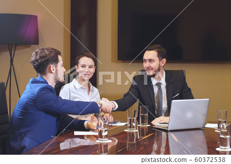 Team of young entrepreneurs meeting in office discussing business plan Team of young entrepreneurs meeting in office discussing business plan 60372538