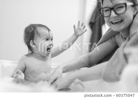 Happy 1 year old Baby in bathtub taking bath in 60375047