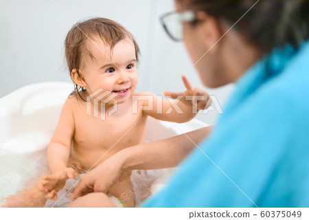 Happy 1 year old Baby in bathtub taking bath in 60375049