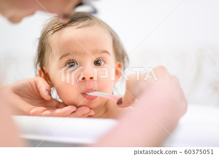 Happy 1 year old Baby in bathtubbrushing teeth in 60375051