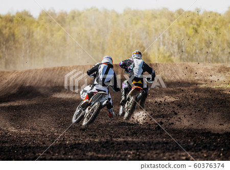 motocross racers on race track 60376374