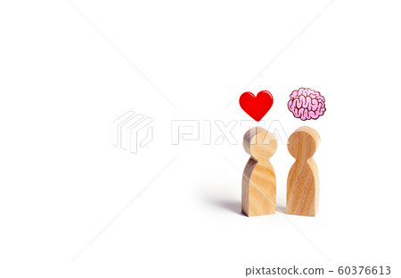 Two wooden figures with the image of the brain and heart. The balance between love and mind. Family versus career or work. Family psychology. Problem of choice. 60376613