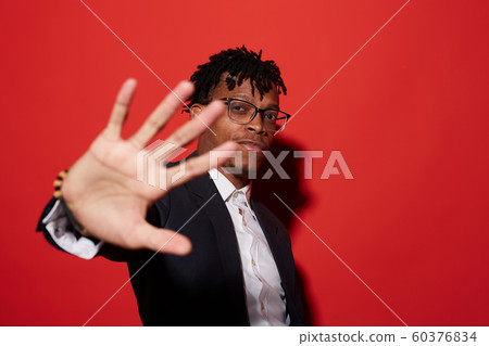 Modern African Man Posing on Red Modern African Man Posing on Red 60376834
