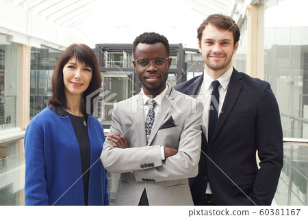 Portrait of three successful businesspeople, business team posing in modern office Portrait of three successful businesspeople, business team posing in modern office 60381167