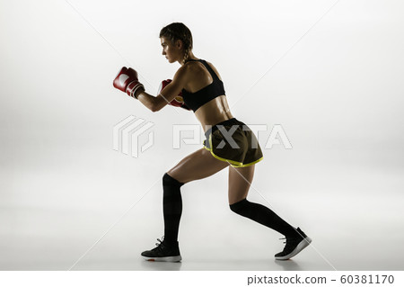 Fit caucasian woman in sportswear boxing isolated on white studio background 60381170