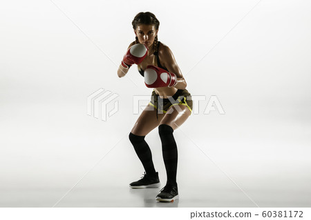 Fit caucasian woman in sportswear boxing isolated on white studio background 60381172