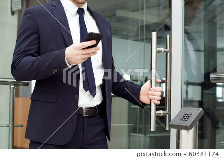 Handsome Businessman Using Smartphone in The Office. 60381174