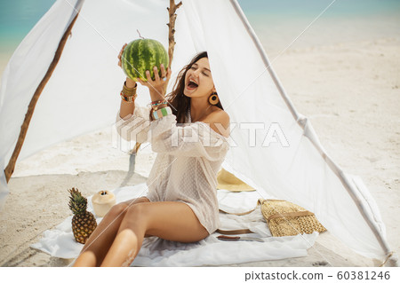 Woman on the Beach Eating Watermelon 60381246