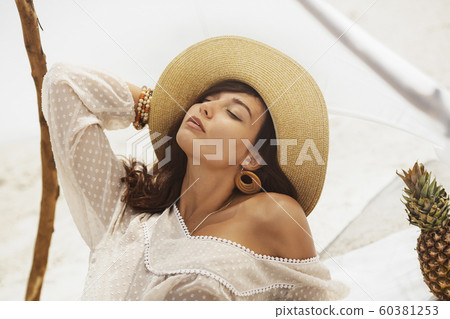 Woman Resting on the Beach During Vacation Woman Resting on the Beach During Vacation 60381253