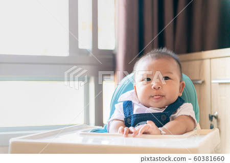 Anorexia, Baby boy sit on feeding chair with 60381660