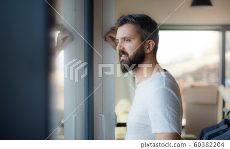Mature man standing in house, moving in new home concept. Mature man standing in house, moving in new home concept. 60382204