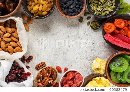 Variety of dry fruits and nuts in bowls 60382479