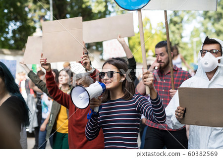 People with placards and amplifier on global strike for climate change. People with placards and amplifier on global strike for climate change. 60382569