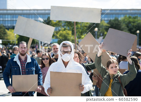 People with placards and protective suit on global strike for climate change. 60382590