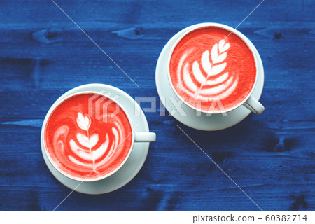 Two cups of cappuccino on wooden table. Two cups of cappuccino on wooden table. 60382714