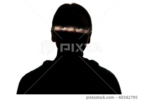 Dramatic portrait of a girl in the dark on white studio background. Dramatic portrait of a girl in the dark on white studio background. 60382795