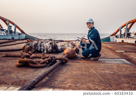 Marine chief officer or chief mate on deck of ship or vessel. He fills up ahts vessel checklist 60383410