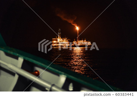 Night view of FPSO tanker vessel near Oil Rig. 60383441