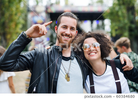 Young Couple At Summer Festival Walking Arm In Stock Photo