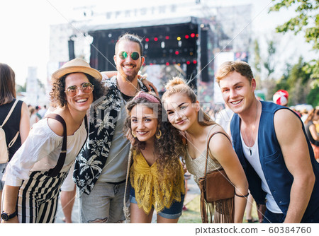Group of young friends at summer festival. Group of young friends at summer festival. 60384760