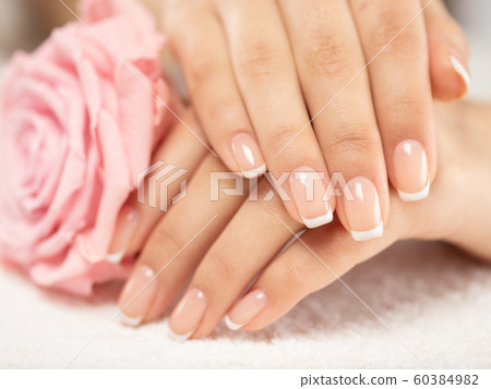 Woman gets manicure procedure in a spa salon. Woman gets manicure procedure in a spa salon. 60384982