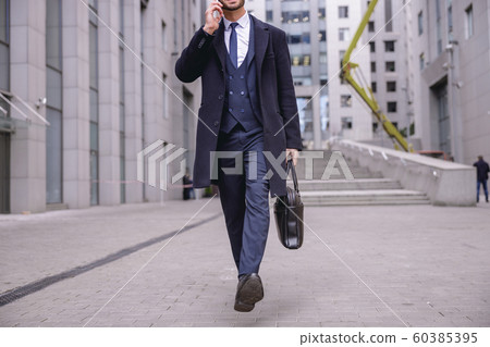 Busy young man going home after work Busy young man going home after work 60385395
