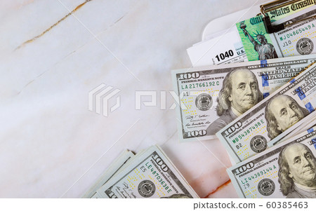 1040 Tax form with refund check and currency US 60385463