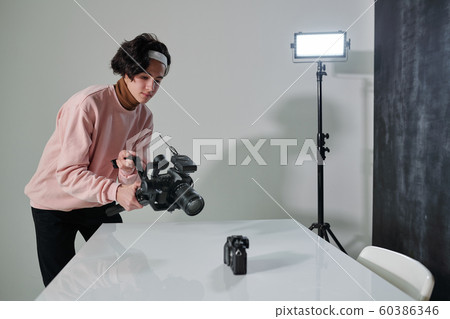 Contemporary male vlogger with video camera shooting new photo equipment 60386346