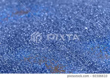 Beautiful Christmas light background. Abstract glitter bokeh and scattered sparkles in gold, on black 60386610