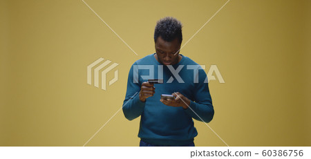 Man paying online with credit card 60386756