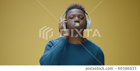 Young man enjoying music 60386835