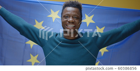 Young man raising the EU flag 60386856