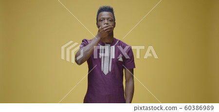 Man covering his mouth with hand Man covering his mouth with hand 60386989