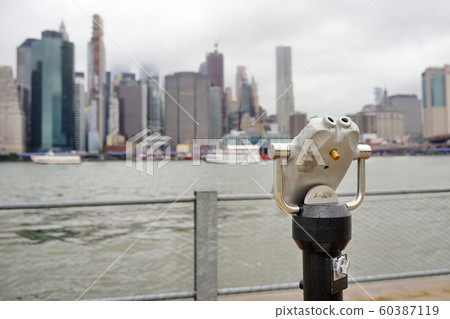 Binoculars looking to the Manhattan skyline over East River Binoculars looking to the Manhattan skyline over East River 60387119