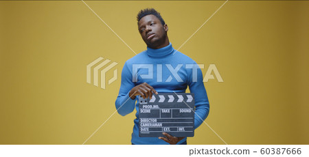 Bored man using film clap Bored man using film clap 60387666