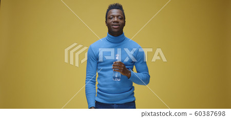 Man opening a bottle and drinking Man opening a bottle and drinking 60387698