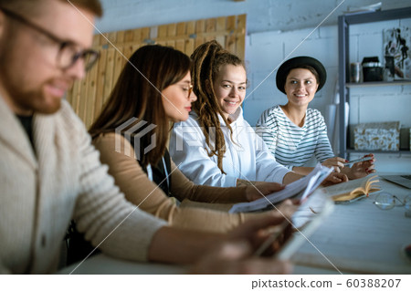 Happy young creative designers coming up with new creative ideas Happy young creative designers coming up with new creative ideas 60388207