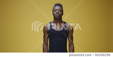 Young man showing muscles Young man showing muscles 60388296