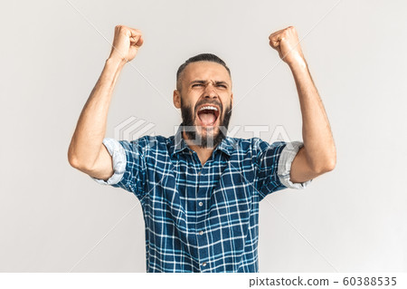 Freestyle. Guy in checkered shirt standing isolated on white hands up screaming excited Freestyle. Guy in checkered shirt standing isolated on white hands up screaming excited 60388535