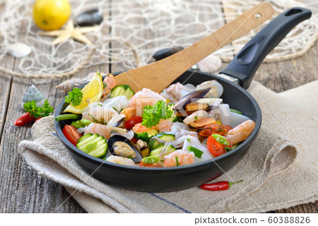 Food combining, mixed seafood and fresh vegetables in a pan before cooking 60388826