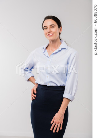 Happy young elegant businesswoman in white shirt looking at you in isolation Happy young elegant businesswoman in white shirt looking at you in isolation 60389070