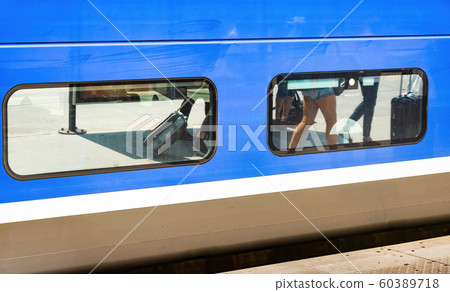 Refelction of passanger on platform in train's windows Refelction of passanger on platform in train's windows 60389718