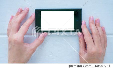 Woman using smartphone with white empty display 60389781
