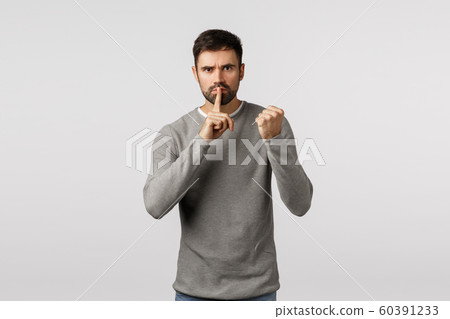 Shut up or else. Threatening angry and serious scary bearded man demand keep silent, dont tell anyone, threaten victim with shaking fist, press index finger to lips, untell, hushing, white background Shut up or else. Threatening angry and serious scary bearded man demand keep silent, dont tell anyone, threaten victim with shaking fist, press index finger to lips, untell, hushing, white background 60391233