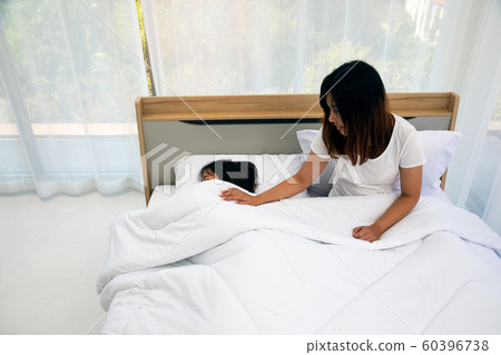 Happy Two Asain sister in bedroom in morning and one call other to wake up at home Happy Two Asain sister in bedroom in morning and one call other to wake up at home 60396738
