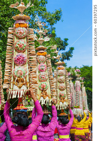 Balinese women with religious offering 60397295