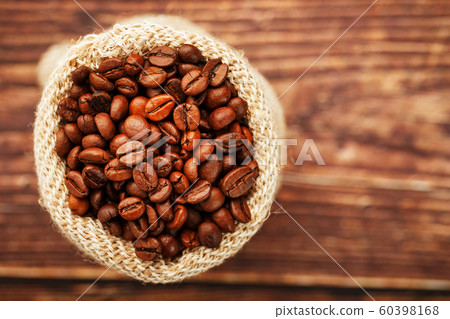Freshly roasted aromatic coffee in a burlap bag on Freshly roasted aromatic coffee in a burlap bag on 60398168