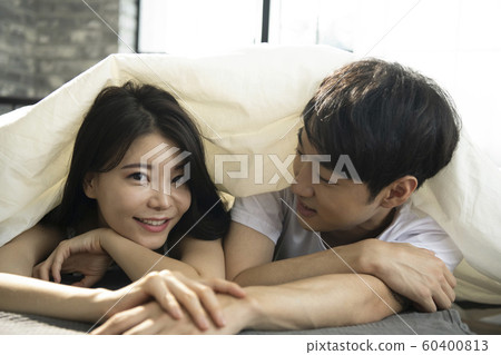 Newlyweds couple relaxing futon Newlyweds couple relaxing futon 60400813